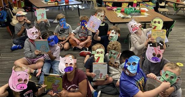  students wearing elephant and pig masks